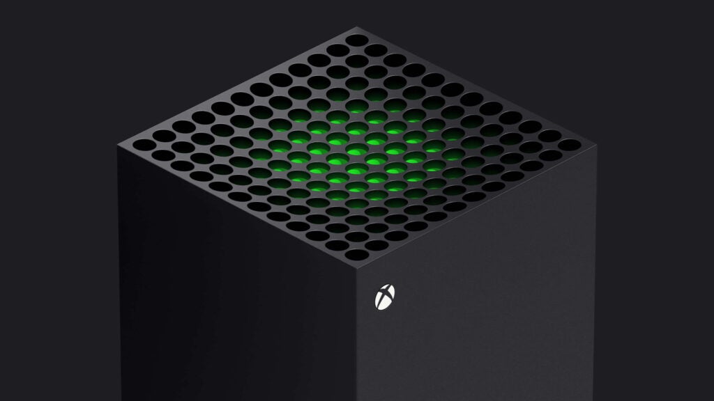 Vue latérale avant supérieure d'une Xbox noire debout sur fond noir