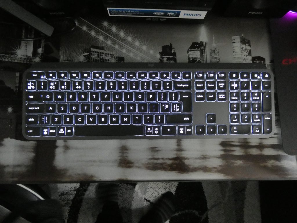 Vue du haut d'un clavier Logitech MX noir posé sur une table avec des lumières sous les touches